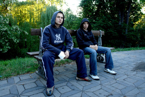 Kościan, ławka przy moście na ul. Wrocławskiej, godz. 20.02. Paweł Kowalski i Ariel Naskręt zastanawiają się jak miło spędzić dzisiejszy wieczór. Paweł kształci się w zawodzie kucharza, a Ariel pracuje w piekarni. 