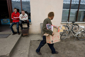 Rąbiń, pod sklepem siedzą od lewej Daniel, Leszek i Daniel niesie kartony.