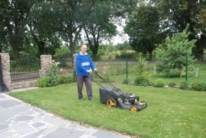 Zdjęcie przedstawia mojego męża Krzysztofa podczas koszenia trawnika przed domem. Zdjęcie wykonane w Cichowie na Osiedlu Brzozowy Gaj. Fot. Teodozja  Ostrowska