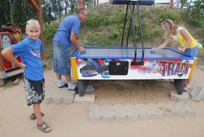 Autor: Ilona Raburska.   Mąż Rafał gra z córką Anetą , kibicuje syn Eryk przed „Chatą Wodnika” w Cichowie