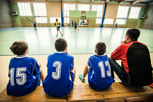 zawodnicy drużyny ze Szkoły Podstawowej w Starej Przysiece Drugiej wraz ze swoim trenerem obserwują w napięciu grę kolegów ze swojego zespołu